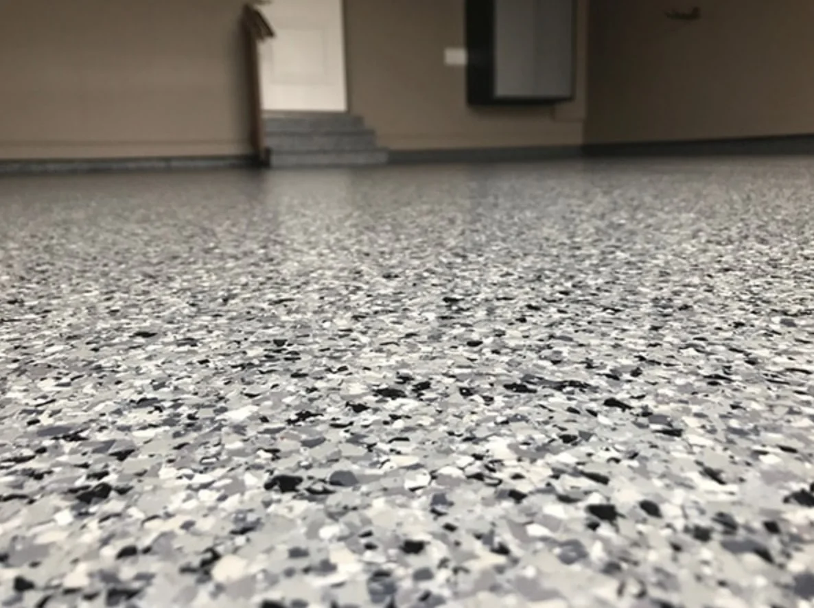 Decorative flake epoxy garage floor in Orlando — multi-color vinyl chip broadcast, close up